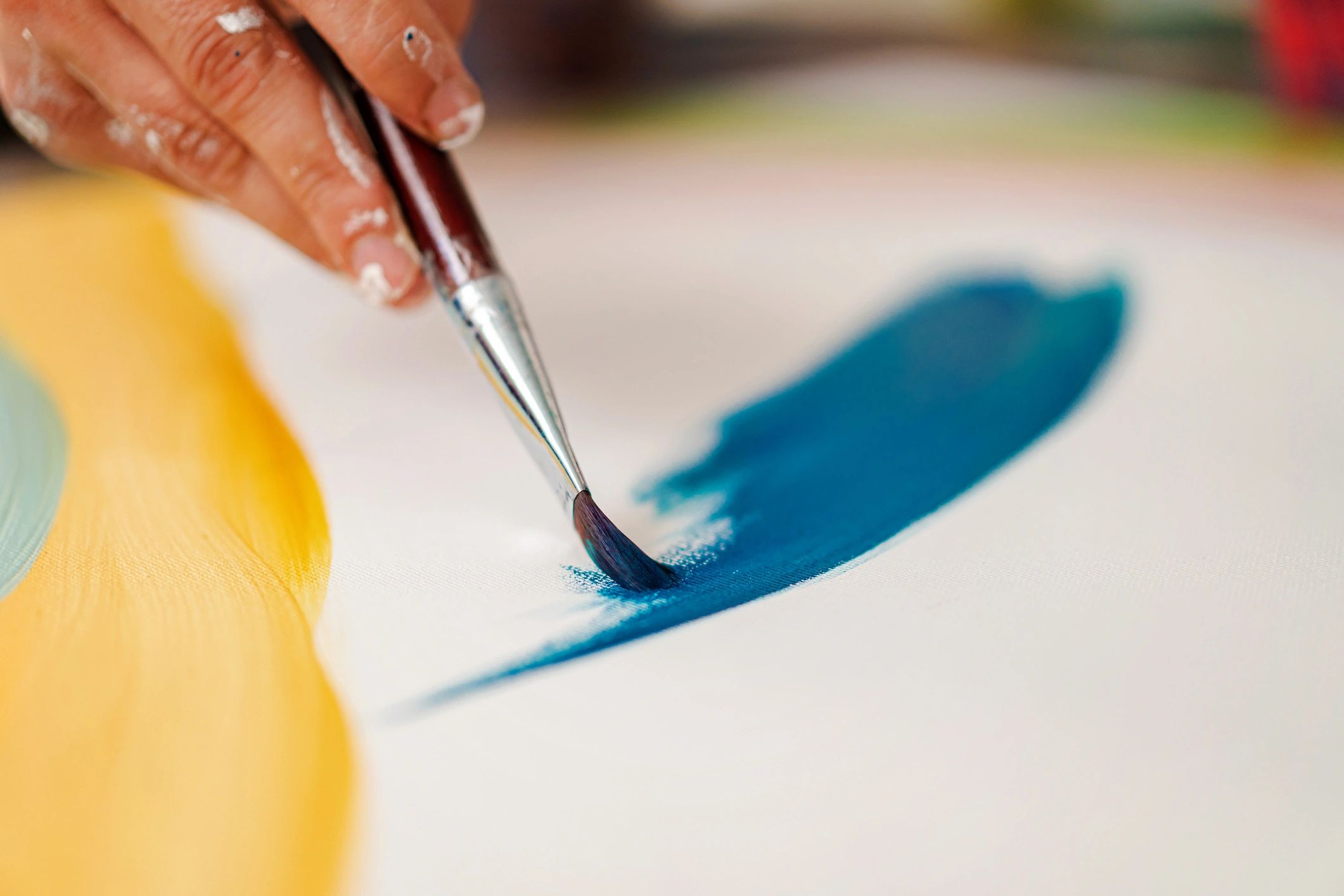 Close view of paint being applied to canvas